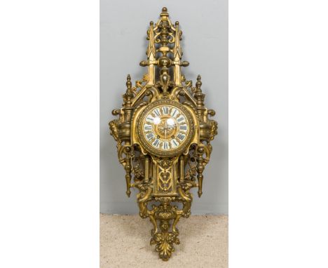A gilt brass cased cartel clockOf large pierced architectural form, the dial set with enamel Roman numerals and twin winding 