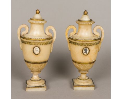 A pair of 18th century carved alabaster lidded urnsOf classical form, with removable lids, one inset with a portrait silhouet