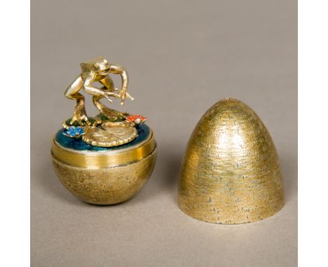 A Stuart Devlin silver gilt novelty egg, hallmarked London 1985, the underside numbered 78The interior containing a leaping f