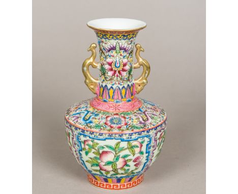 A Chinese porcelain twin handled baluster vaseBrightly enamelled with pomegranate vignettes and mythical beasts amongst lotus