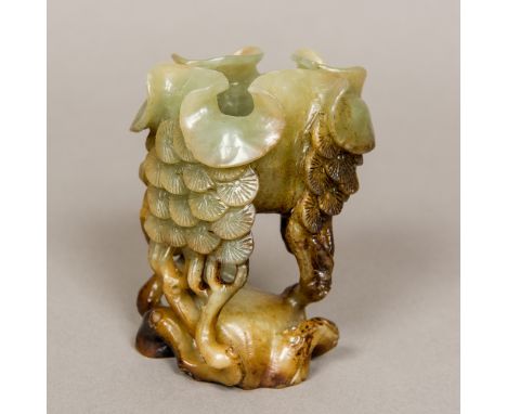 A Chinese carved jade brush washerThe shaped bowl supported on tree form legs.  10.5 cm high.  CONDITION REPORTS: Generally i