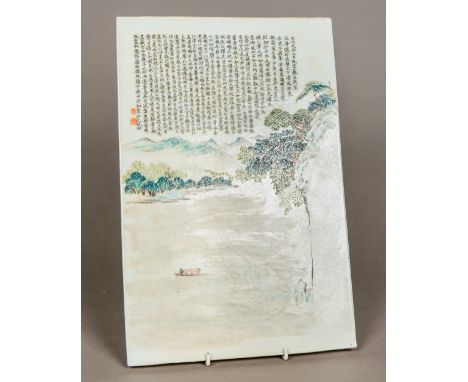 A Chinese porcelain plaqueDecorated with a boatman in a river landscape and extensive calligraphic text and red seal marks, u