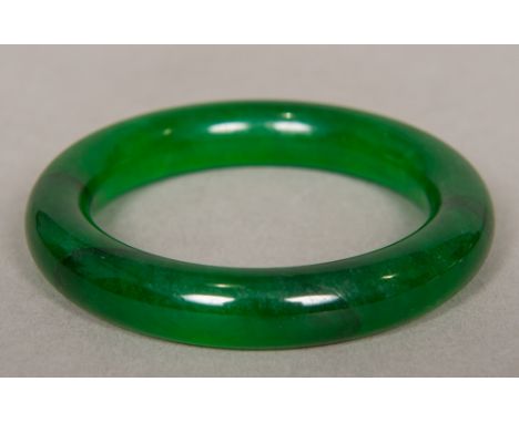 A Chinese carved spinach jade bangle8 cm diameter.  CONDITION REPORTS: Generally good, expected wear. 