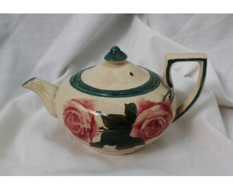 A Llanelly pottery teapot painted with red roses and leaves to green line decoration, 17cm long CONDITION REPORT: Lid -  regl