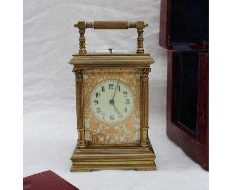 A late 19th century gilt brass striking and quarter repeating carriage clock, with a carrying handle and repeat button, ename