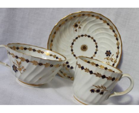 An 18th century Worcester porcelain trio comprising a tea cup, coffee cup and saucer, decorated with bell flowers and gilt le