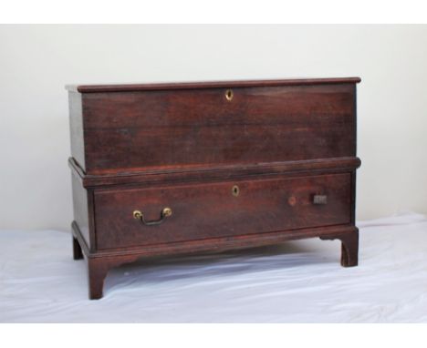 An 18th century oak coffer, the planked rectangular top above a single drawer on bracket feet, 104cm wide x 52cm deep x 73cm 
