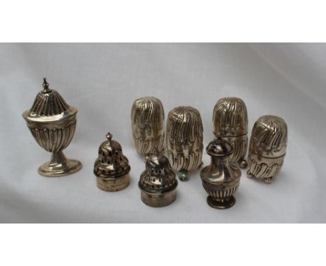 A pair of late Victorian silver pepperettes of domed swirling shape on three ball feet, London, 1893, together with another p