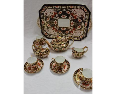 A Royal Crown Derby tea set, 2451 pattern decorated in the Imari palette, including a tray, teapot, cream jug, sucrier and co