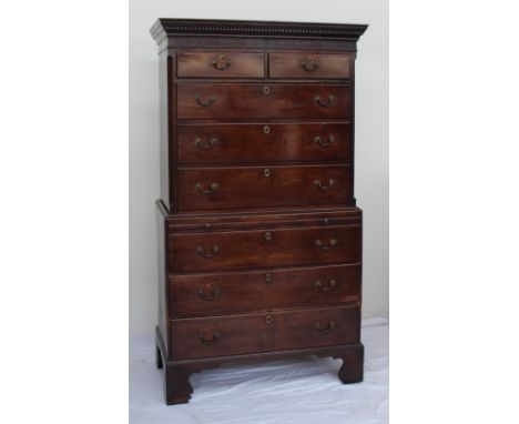 A George III mahogany chest on chest, the moulded dentil cornice above a blind fretwork frieze, two short and three long draw