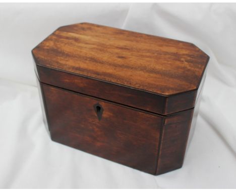 A 19th century mahogany tea caddy, of rectangular form with cut corners, with a single lid enclosing two compartments, 20.5cm
