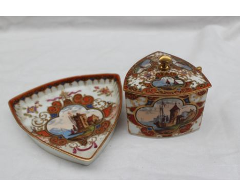 A Dresden porcelain cabinet cup, cover and saucer, of triangular shape decorated with a castle by a lake within a quatrefoil 