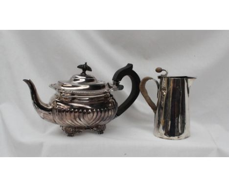 An Edward VII silver teapot, with a half gadrooned body on scrolling feet, London, 1902 together with a silver hot water jug,