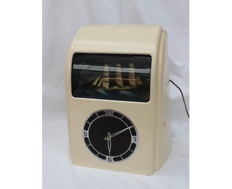 A Vitascope Industries Ltd bakelite Art Deco style electric ship automata clock the cream painted case with a curved front an