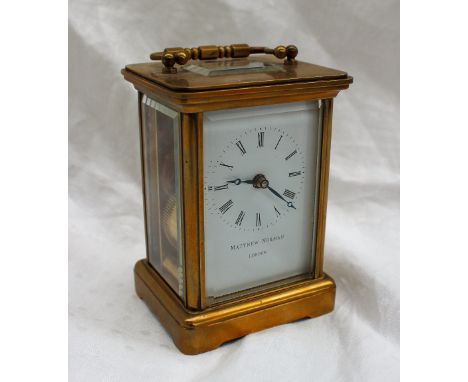 A brass cased carriage clock the enamel dial with Roman numerals inscribed Matthew Norman, London, height to top of handle 14