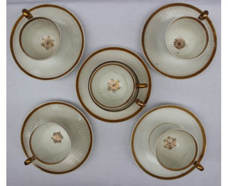 A Swansea Paris flute part teaset comprising five cups and saucers, breakfast cup, slops basin, sugar box and cover and a sid