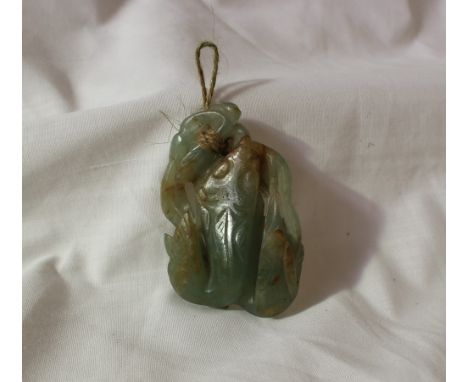 A jade carving of a fish and leaves, 7cm long
