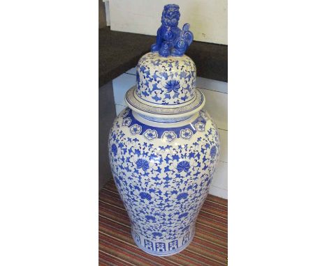 TEMPLE JAR WITH COVER, Oriental style blue and white of large proportions with a foo dog finial and leaf and floral decoratio