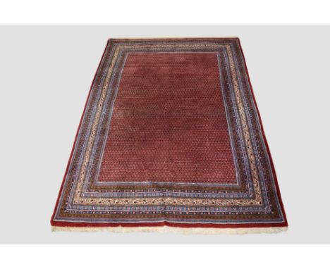 Saraband carpet, north west Persia, circa 1950s-60s, 11ft. 7in. X 8ft. 2in. 3.53m. X 2.49m. Light red field with all over tin