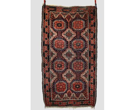 Two Baluchi rugs, Khorasan, north east Persia, early 20th century, the first:  5ft. 10in. X 3ft. 8in. 1.78m. X 1.12m. Overall
