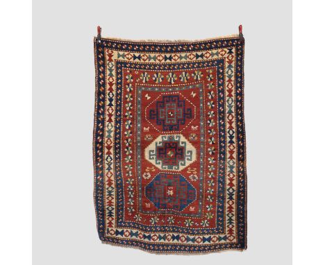 Kazak triple medallion rug, south west Caucasus, late 19th/early 20th century, 6ft. 7in. X 4ft. 11in. 2.01m. X 1.50m. Minimal