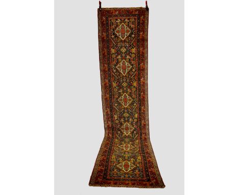 Kurdish runner, (reduced)  west Persia, circa 1920-30s, 13ft. 3in. X 3ft. 1in. 4.04m. X 0.94m. Reduced in length by horizonta