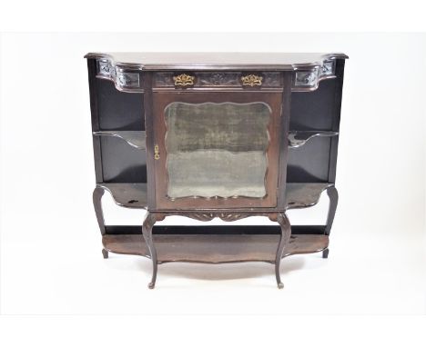 An Edwardian mahogany display cabinet, of shaped form, with one frieze drawer above a glazed door flanked by two shelves, on 