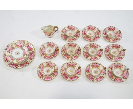A porcelain tea service painted with roses with gilt leaves, retailed by T Goode &amp; Co, comprising eleven tea cups, twelve