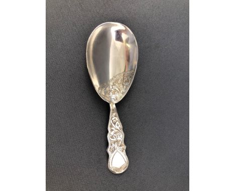 A silver caddy spoon with shaped bright cut engraved handle and similarly decorated tear drop bowl, Birmingham 1910, 9cm high