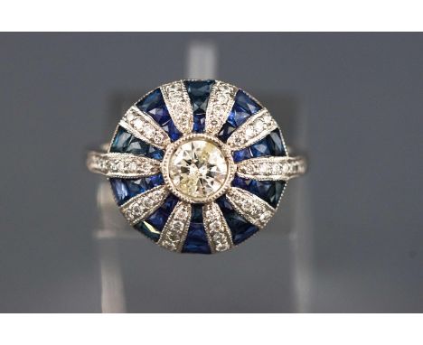 A white metal cluster ring. Set with a central round brilliant cut diamond of approx. 0.50cts. Colour: I/J Clarity: I1. Furth