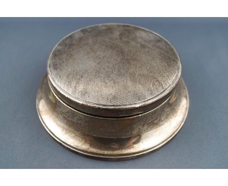 A silver jewel casket of lowered capstan form, the lid engraved with engine turning lifting to reveal a mirror and a padded s