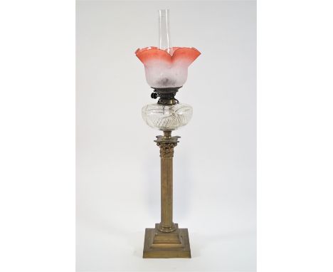 A 19th century oil lamp, with glass shade and chimney above a cut glass reservoir, supported by a brass corinthian capital on