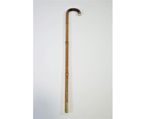 A walking stick with gold band and snakeskin and ivory handle, 89cm high