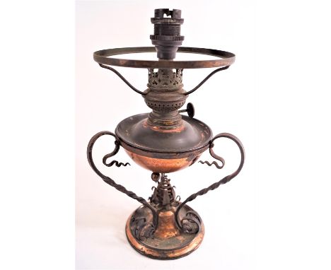 A copper Arts and Crafts style lamp, with plain hemispherical reservoir on a base of three twisted S scroll supports, 28cm hi