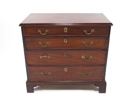 An 18th century chest of four long drawers, of plain rectangular form, with plain loop handles and Rococo cartouches, raised 