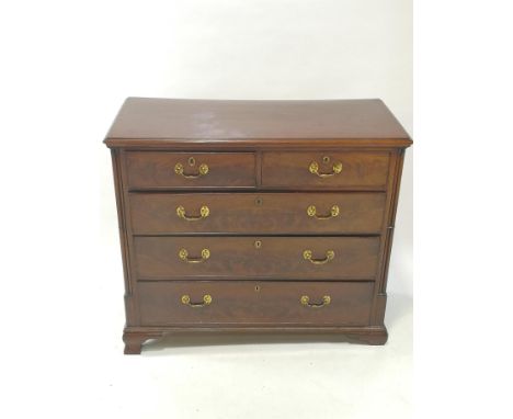 A George III mahogany chest of two short and three long drawers, with triple column corners and ogee bracket feet, 104cm high