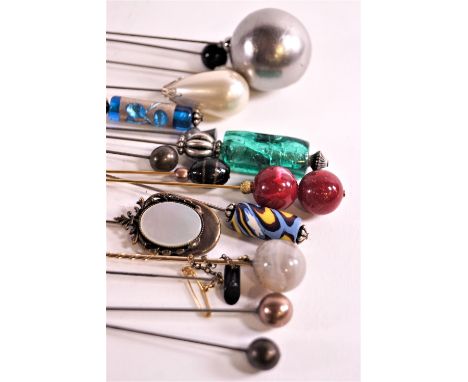 A collection of hat pins, including glass examples simulated pearl and an agate example