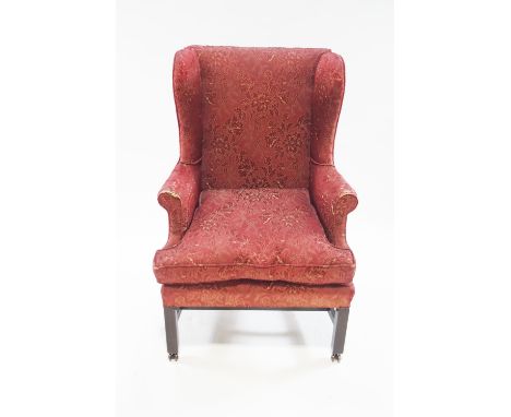 A 19th century style wingback armchair on square mahogany legs with unusual brass casters, 112cm high, 74cm wide, 74cm deep