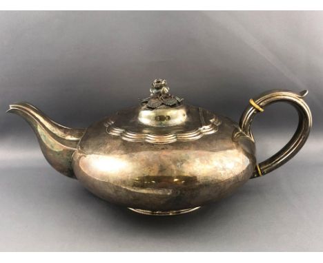 A silver low form plain teapot with domed lid set a cast 3D floral finial and set a silver handle with insulators raised on a