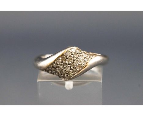 A white metal abstract design ring set with thirty four round brilliant cut diamonds of approx. total weight 0.34cts. Unteste