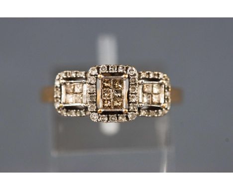 A yellow and white metal dress ring set with champagne princess cut diamonds and single cut diamonds. Stamped total diamond w