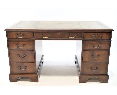 A George III style mahogany pedestal desk with green leather inset top above three drawers above a further three drawers to e