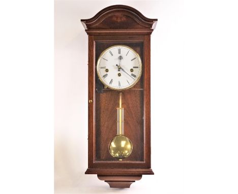 A 20th century Comitti mahogany cased regulator wall clock, with arched cornice above a round white dial enclosing a chiming 