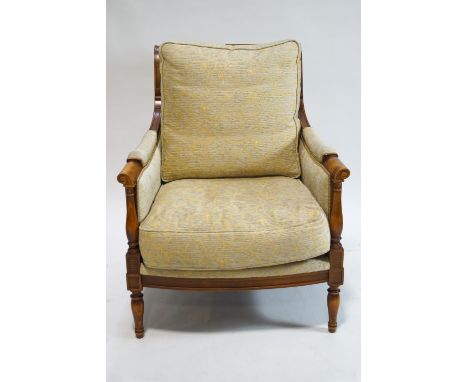A Wesley Barrel Moreton armchair, with loose cushion on turned legs