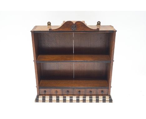 A 19th century oak two tier hanging wall shelf with shaped crest, three drawers and painted flared base, 63cm high, 61cm wide