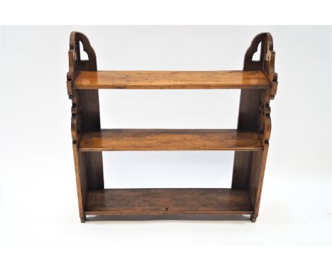 A 19th century mahogany three tier wall shelf, with pierced supports, 63cm high, 60cm wide, 15cm deep