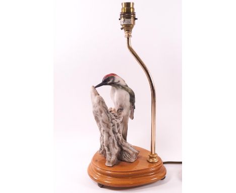 A Capodimonte Woodpecker '1983', on a lamp stand, signed and stamped (C) 1983 Florence, the bird 19cm high