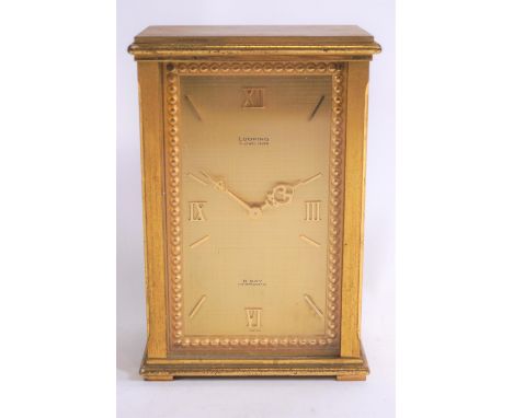 A Looping 15 jewel, lever escapement eight day, antimagnetic alarm clock, in rectangular gilt metal case, 14cm high, 9cm wide