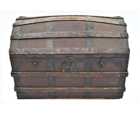 A domed trunk with two handles, the top opening to reveal a paper lined interior, 57cm high, 77cm wide, 46cm deep