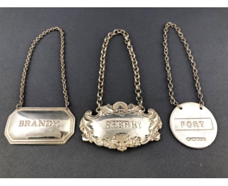 A silver rococo style bottle ticket with scrolling shell work for sherry, stamped 925 and two others 45grams